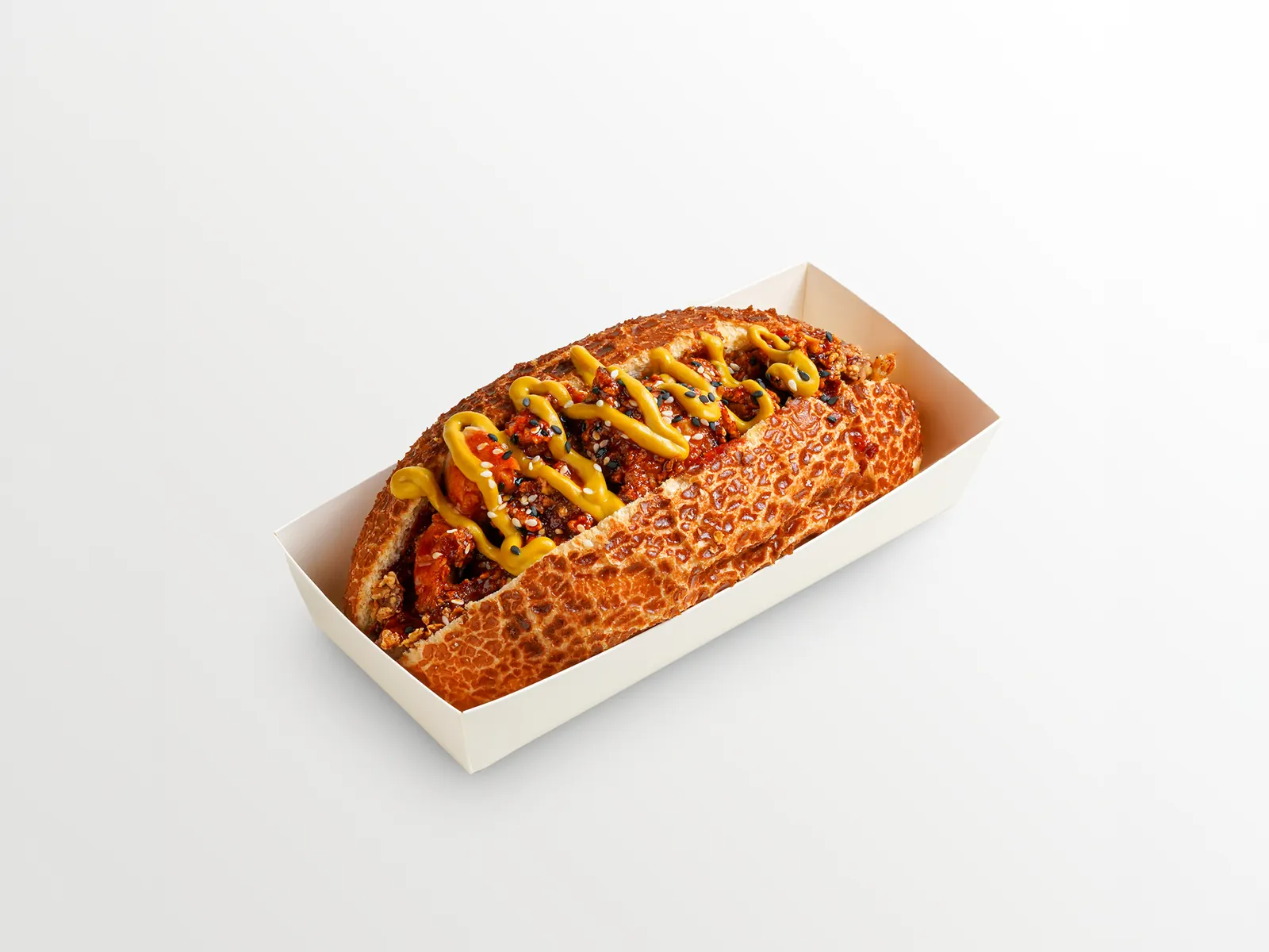 After food photo editing: the same hotdog on a clean white background with corrected colour and exposure and the tray marks removed