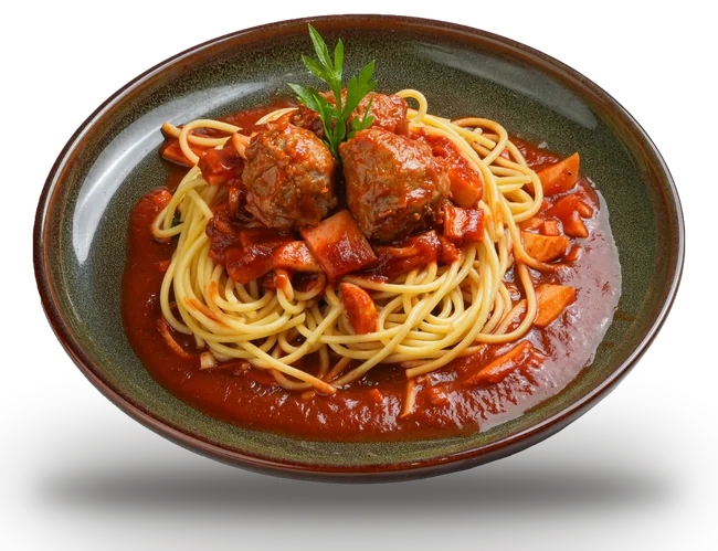 Spaghetti and meatballs in tomato sauce on a glazed stoneware plate