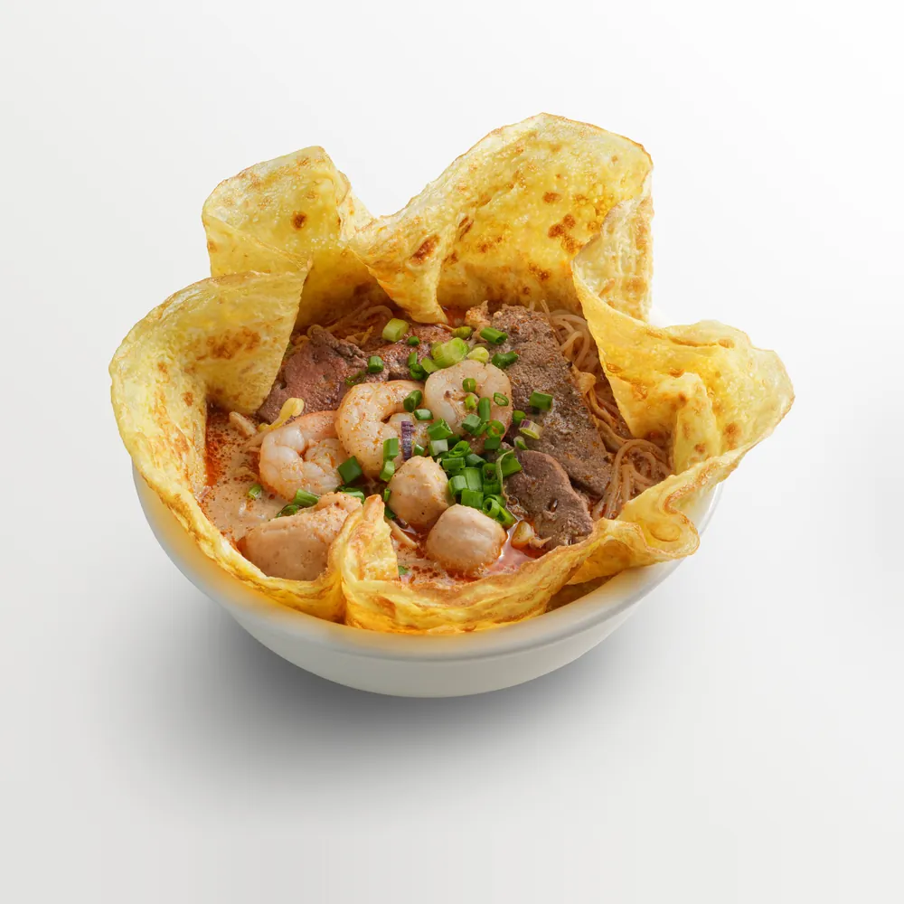 Curry mee with prawns, fishballs and beef slices in a crisp egg-crepe basket
